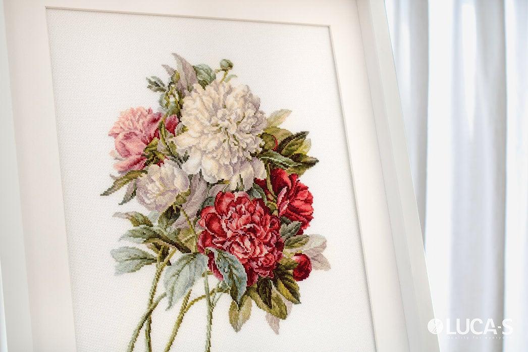 Piones B2355L Counted Cross-Stitch Kit featuring colorful threads, canvas, and needle for crafting.